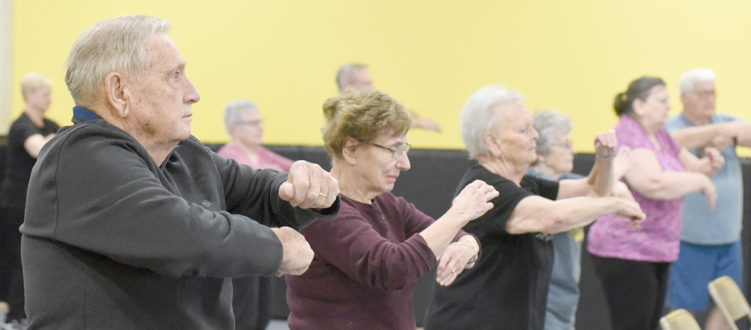 Seniors perform an exercise during a fitness class at the Lone Tree Wellness Center. This exercise helps keep motor skills sharp. The class meets twice a week.